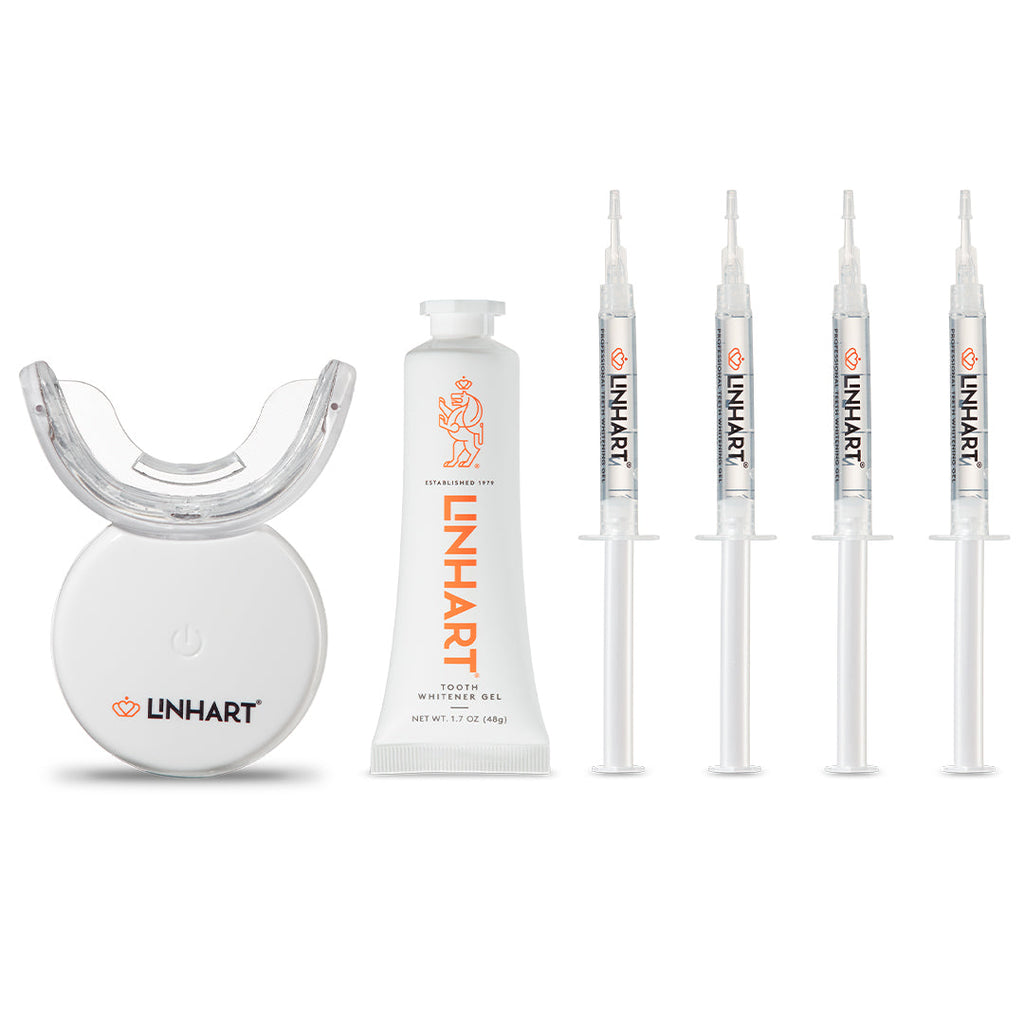 The Professional Whitening Kit featuring a white LED light device, a white gel tube, and four clear syringes with orange LINHART branding.