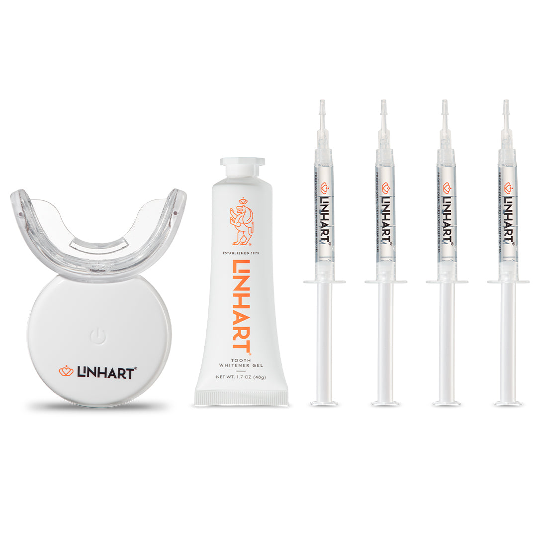 The Professional Whitening Kit featuring a white LED light device, a white gel tube, and four clear syringes with orange LINHART branding.
